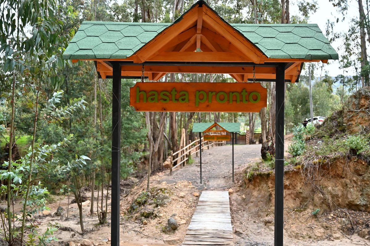 Arco de bienvenida de madera en la entrada del glamping